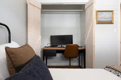 a bedroom with a desk with a computer and a chair at 10 min to Beach Central Villa in San Diego