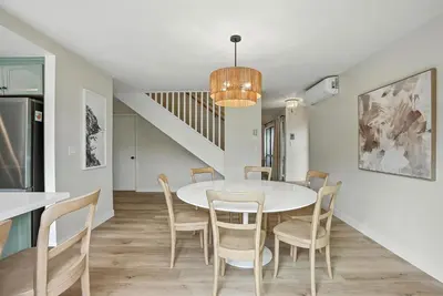 a dining room with a white table and chairs at Solana Beach Gem - AC and Beach Access in Solana Beach