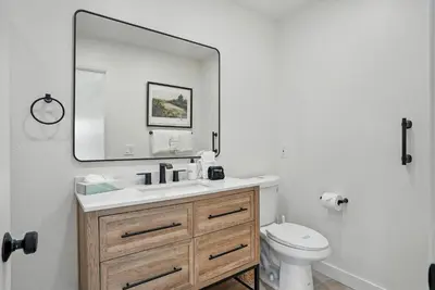a bathroom with a sink and a mirror and a toilet at Solana Beach Gem - AC and Beach Access in Solana Beach