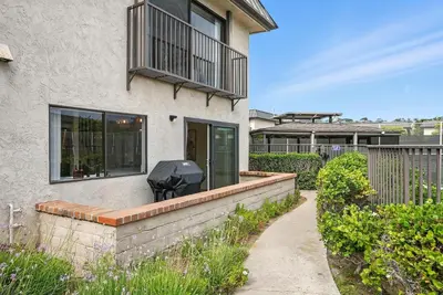 a house with a balcony with a black object on it at Solana Beach Gem - AC and Beach Access in Solana Beach