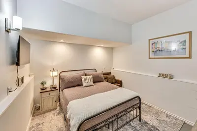 a small bedroom with a bed and a television at Extended-Stay Suite Near I-15 in Lake Elsinore! in Lake Elsinore