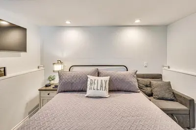 a bedroom with a large bed and a couch at Extended-Stay Suite Near I-15 in Lake Elsinore! in Lake Elsinore