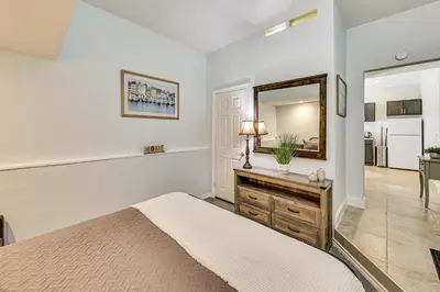 a bedroom with a bed and a mirror at Extended-Stay Suite Near I-15 in Lake Elsinore! in Lake Elsinore
