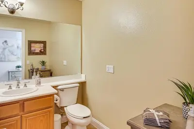 a bathroom with a toilet and a sink and a mirror at Extended-Stay Suite Near I-15 in Lake Elsinore! in Lake Elsinore