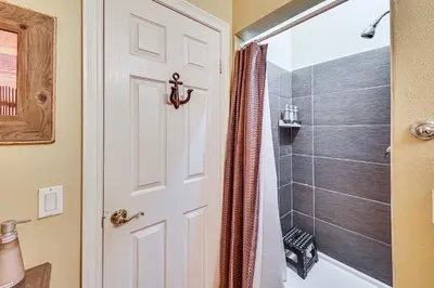 a bathroom with a shower and a white door at Extended-Stay Suite Near I-15 in Lake Elsinore! in Lake Elsinore