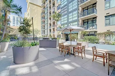 a patio with a table and chairs and an umbrella at Gaslamp District Heart of San Diego in San Diego