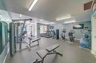 a gym with several treadmills and machines in it at Gaslamp District Heart of San Diego in San Diego