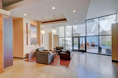 a large living room with couches and chairs and windows at Gaslamp District Heart of San Diego in San Diego