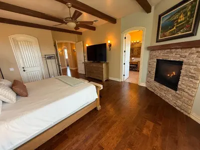 a bedroom with a bed and a fireplace at La Bella Vista Estate in Fallbrook