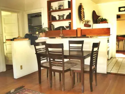 a table and chairs in a kitchen with a counter at Mission Beach Cottage in San Diego