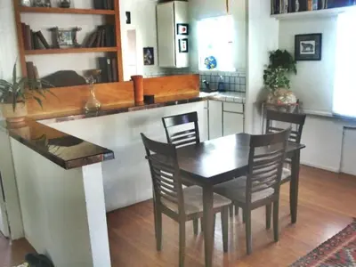 a kitchen with a table and chairs in a kitchen at Mission Beach Cottage in San Diego