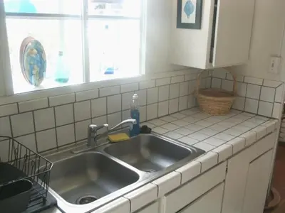 a kitchen counter with a sink and a window at Mission Beach Cottage in San Diego