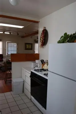 a kitchen with a black stove top oven next to at Mission Beach Cottage in San Diego