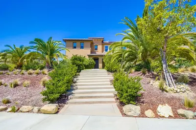 a house with palm trees in front of it at Daydream Palace in Chula Vista