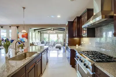 a kitchen with a sink and a stove at Daydream Palace in Chula Vista