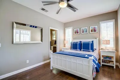 a bedroom with a bed and a ceiling fan at Daydream Palace in Chula Vista