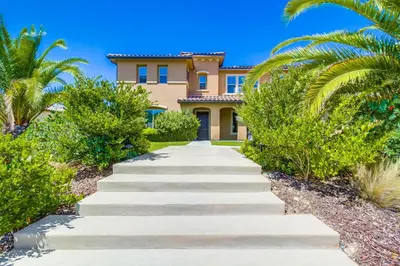 a pathway leading to a house with palm trees at Daydream Palace in Chula Vista