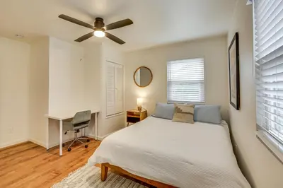 a bedroom with a bed and a desk and a ceiling fan at 2 Mi to Ocean Pet-Friendly Imperial Beach Retreat in Imperial Beach