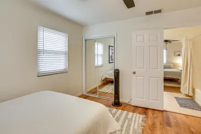 a bedroom with a bed and a mirror at 2 Mi to Ocean Pet-Friendly Imperial Beach Retreat in Imperial Beach