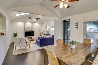 a living room with a table and a blue couch at 2 Mi to Ocean Pet-Friendly Imperial Beach Retreat in Imperial Beach