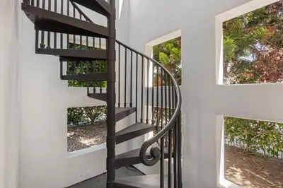 a staircase in a house with two windows at Seaside Spiral in San Diego