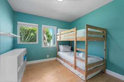 a bedroom with blue walls and bunk beds at Seaside Spiral in San Diego
