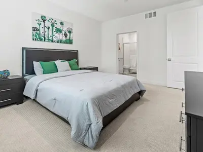 a bedroom with a large bed with green pillows at Beautiful Irvine Grand Park Community Cozy and Comfortable Home in Irvine