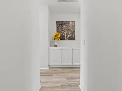 a white room with a vase of flowers on a counter at Beautiful Irvine Grand Park Community Cozy and Comfortable Home in Irvine