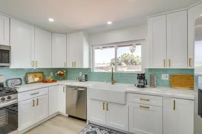 a kitchen with white cabinets and a window at Day Trip to San Diego San Marcos Home Near Hiking in San Marcos