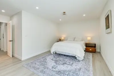 a white bedroom with a bed and a rug at Day Trip to San Diego San Marcos Home Near Hiking in San Marcos