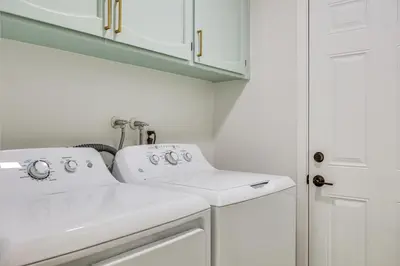a bathroom with two sinks and white cabinets at Day Trip to San Diego San Marcos Home Near Hiking in San Marcos