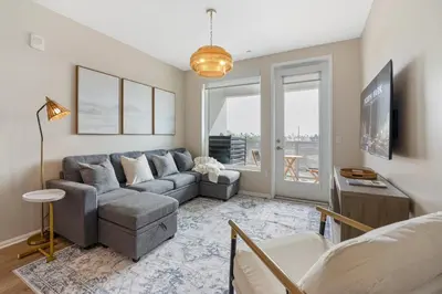 a living room with a couch and a tv at LUX Oasis North Park, King Beds, Workspaces, Parking in San Diego
