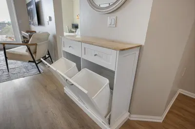 a bathroom with a vanity with a mirror and a chair at LUX Oasis North Park, King Beds, Workspaces, Parking in San Diego