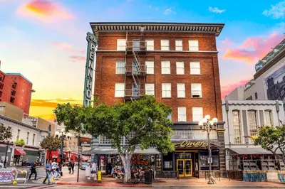 a tall brick building on a city street at The Historic Penn Hotel in San Diego