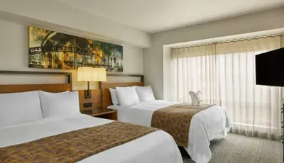 a hotel room with two beds and a tv at Marriott Vacation Club San Diego Studio Apartment with Resort Access in San Diego