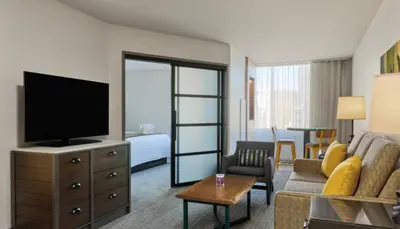 a living room with a television and a living room with a couch at Marriott Vacation Club San Diego Studio Apartment with Resort Access in San Diego