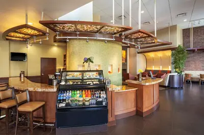 a restaurant with a counter and a bar at Hyatt Place San Diego-Vista/Carlsbad in Vista