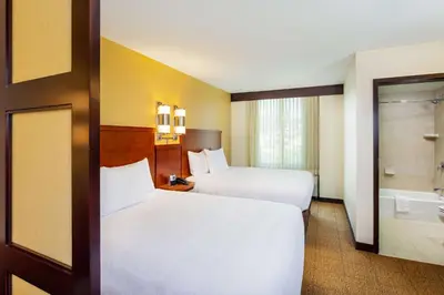 a hotel room with two beds and a bathroom at Hyatt Place San Diego-Vista/Carlsbad in Vista