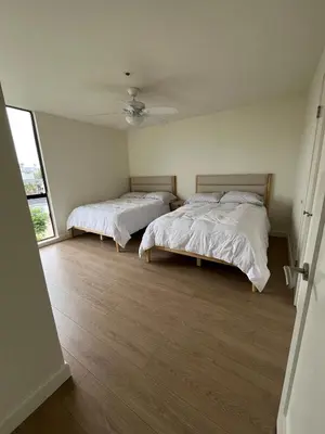 a bedroom with two beds and a ceiling fan at Sail Bay Condo in PB Bay View close to the Ocean! 30 day stay is required in San Diego