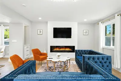 a living room with blue furniture and a fireplace at Xlnc Exotic Home Witt Rd Poway in Poway
