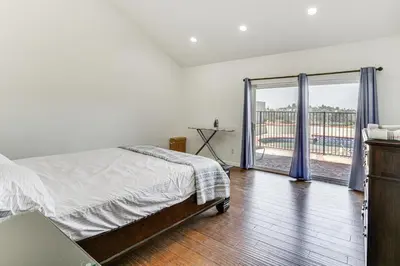 a bedroom with a bed and a sliding glass door at Spacious Getaway with Pool and Spa in La Mesa! in La Mesa