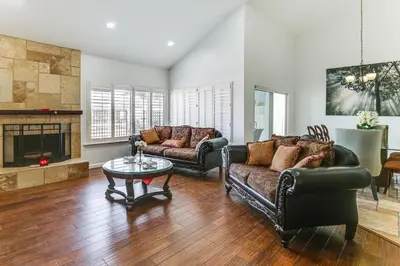 a living room with two couches and a fireplace at Spacious Getaway with Pool and Spa in La Mesa! in La Mesa