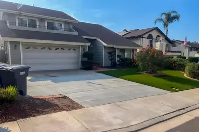 a house with a driveway and a garage at Spacious Getaway with Pool and Spa in La Mesa! in La Mesa