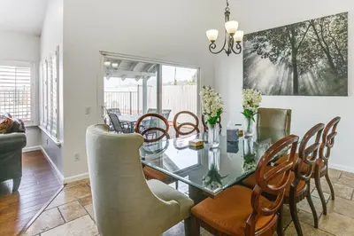 a dining room with a glass table and chairs at Spacious Getaway with Pool and Spa in La Mesa! in La Mesa