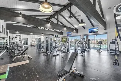 a gym with several treadmills and machines in it at Luxury Oasis Resort Pool&Spa Fitness Arcade in Ladera Ranch