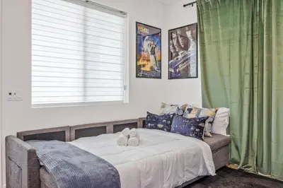 a bedroom with a bed with two stuffed animals on it at Luxury Resort Pool Spa Arcade Movie Gym in Mission Viejo