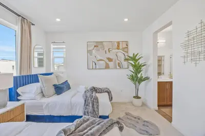 a bedroom with a bed and a potted plant at Luxury Resort Pool Spa Arcade Movie Gym in Mission Viejo