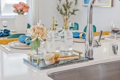 a kitchen counter with two bottles and a sink at Luxury Resort Pool Spa Arcade Movie Gym in Mission Viejo