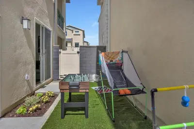 a small balcony with a table and a chair at Luxury Resort Pool Spa Arcade Movie Gym in Mission Viejo