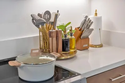 a pot on the stove with a bunch of kitchen utensils at Luxury Resort Pool Spa Arcade Movie Gym in Mission Viejo